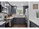 Modern kitchen with gray cabinets, stainless steel appliances, and quartz countertops at 11110 105Th Ave, Largo, FL 33778