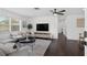 Bright and airy living room with a ceiling fan, large windows, and dark hardwood floors at 11110 105Th Ave, Largo, FL 33778
