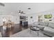 Bright open-concept living room featuring dark floors and modern decor that connects to the kitchen at 11110 105Th Ave, Largo, FL 33778