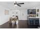 Open concept living room featuring a modern kitchen, dining area, and dark wood floors at 11110 105Th Ave, Largo, FL 33778