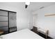 Bright main bedroom features a ceiling fan, dark wood floors, and closet with sliding doors at 11110 105Th Ave, Largo, FL 33778