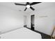 Bright main bedroom features a ceiling fan, dark wood floors, and closet with open door at 11110 105Th Ave, Largo, FL 33778