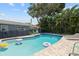 Backyard pool with patio and lounge chairs, surrounded by lush tropical landscaping and privacy fence at 11110 105Th Ave, Largo, FL 33778
