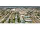 Wide aerial view of neighborhood homes, shopping centers, and a community pool by the gulf coast at 11447 Park Blvd # 205, Seminole, FL 33772