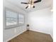 The bedroom features wood-look vinyl flooring, light-blocking shutters, and a ceiling fan at 11447 Park Blvd # 205, Seminole, FL 33772