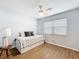 Bedroom featuring vinyl flooring, a ceiling fan, and a daybed with built in storage drawers and plenty of light at 11447 Park Blvd # 205, Seminole, FL 33772