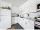 This fully renovated kitchen features white shaker cabinets at 11447 Park Blvd # 205, Seminole, FL 33772