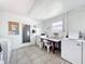 Bright community laundry room with multiple machines, tiled floors, counter for folding, and posted instructions at 11447 Park Blvd # 205, Seminole, FL 33772