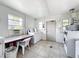 Bright community laundry room with multiple machines, tiled floors, counter for folding, and natural light at 11447 Park Blvd # 205, Seminole, FL 33772