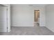 Bright bedroom with neutral carpet and walls; bathroom with glass shower door visible at 11742 Blackbrook Ct, Seffner, FL 33584
