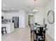 Open-concept kitchen with stainless steel appliances, island seating, and adjacent dining area at 11742 Blackbrook Ct, Seffner, FL 33584