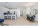 Bright living space with stainless steel appliances, island seating, and adjacent dining area at 11742 Blackbrook Ct, Seffner, FL 33584