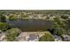 Aerial shot of a home by a lake, with lush landscaping and neighborhood views at 12416 Queensland Ln, Tampa, FL 33625