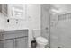 Modern bathroom featuring a vessel sink, gray vanity, and a glass-enclosed shower with marble-style tile at 12416 Queensland Ln, Tampa, FL 33625