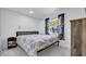 Cozy bedroom showcasing a comfortable bed, window with colorful curtains, and marble tile floors at 12416 Queensland Ln, Tampa, FL 33625