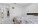 Inviting bedroom featuring a patterned comforter, marble tile floors, and access to hallway at 12416 Queensland Ln, Tampa, FL 33625