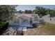 Charming single-story home with fresh exterior paint, solar panels, and a view of the serene lake at 12416 Queensland Ln, Tampa, FL 33625