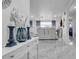 Stylish foyer showcasing elegant marble floors, a decorative table, and a view of the living room at 12416 Queensland Ln, Tampa, FL 33625