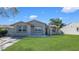 Charming single-story home with a well-manicured lawn and inviting curb appeal at 12416 Queensland Ln, Tampa, FL 33625