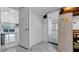 Hallway leading to the pool, storage, and playroom with marble floors at 12416 Queensland Ln, Tampa, FL 33625
