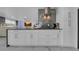 Modern kitchen with granite countertops, stainless steel appliances, and sleek white cabinets at 12416 Queensland Ln, Tampa, FL 33625