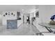 Modern kitchen with white cabinets, marble countertops, stainless steel appliances, and stylish tile floors at 12416 Queensland Ln, Tampa, FL 33625