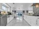 Modern kitchen with stainless steel appliances, granite countertops, and access to the pool area at 12416 Queensland Ln, Tampa, FL 33625