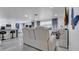 Bright living room with modern leather seating, marble floors, and an open concept design at 12416 Queensland Ln, Tampa, FL 33625