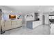Spacious living room featuring modern decor, marble floors, and a stylish kitchen island at 12416 Queensland Ln, Tampa, FL 33625