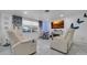 Comfortable living room featuring white leather seating, a fireplace, and stylish decor accents at 12416 Queensland Ln, Tampa, FL 33625