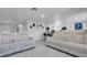 Spacious living area with comfortable leather seating, marble floors, and open access to the kitchen at 12416 Queensland Ln, Tampa, FL 33625