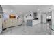 Open-concept living space with stylish kitchen, cozy seating, and modern decor at 12416 Queensland Ln, Tampa, FL 33625