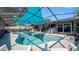 Inviting screened-in pool with modern patio and outdoor kitchen, perfect for entertaining and relaxation at 12416 Queensland Ln, Tampa, FL 33625