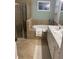 Bathroom featuring a soaking tub with tile surround, glass enclosed shower, and double sink vanity at 12619 Richezza Dr, Venice, FL 34293