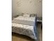 Inviting bedroom with floral bedding, gray accents, and decorative seashell art at 12619 Richezza Dr, Venice, FL 34293