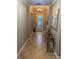 Inviting hallway featuring neutral colors, decorative lighting, and elegant tile flooring at 12619 Richezza Dr, Venice, FL 34293