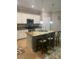 Well-equipped kitchen with granite countertops, white cabinets, and a breakfast bar with seating at 12619 Richezza Dr, Venice, FL 34293