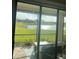 Screened patio overlooking a serene pond with lush green landscaping and peaceful scenery at 12619 Richezza Dr, Venice, FL 34293
