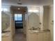 Elegant bathroom with granite counters, double sinks, and access to the main bedroom at 13313 Gasparilla Rd # 401, Placida, FL 33946