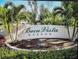 Boca Vista Harbor community entrance sign surrounded by lush landscaping and palm trees at 13313 Gasparilla Rd # 401, Placida, FL 33946