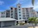 Beautiful condo with multiple floors, light pink exterior, and blue window shutters at 13313 Gasparilla Rd # 401, Placida, FL 33946