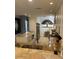 Modern kitchen with granite countertops, stainless steel appliances, and unique tree-themed art at 13313 Gasparilla Rd # 401, Placida, FL 33946