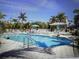 Community pool area with lush tropical landscaping, lounge chairs, and inviting blue water at 13313 Gasparilla Rd # 401, Placida, FL 33946