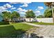 Spacious backyard featuring a stone paver path and mature landscaping at 13325 1St E St, Madeira Beach, FL 33708