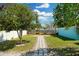 Large backyard with a stone paver path leading to two kayaks, fully fenced at 13325 1St E St, Madeira Beach, FL 33708