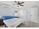Bedroom with light gray walls, wood-look flooring, and a closet with bi-fold doors at 13325 1St E St, Madeira Beach, FL 33708