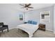 Bedroom with light gray walls, wood-look flooring, and a ceiling fan with light fixture at 13325 1St E St, Madeira Beach, FL 33708