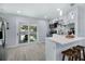 Modern kitchen with white cabinets, a breakfast bar, and stainless steel appliances, perfect for cooking and entertaining at 13325 1St E St, Madeira Beach, FL 33708