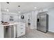 Open-concept kitchen with stainless steel appliances, white countertops, and easy access to living areas at 13325 1St E St, Madeira Beach, FL 33708