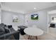 Comfortable living room featuring modern flooring, a stylish sofa, and a seamless flow to the dining area at 13325 1St E St, Madeira Beach, FL 33708